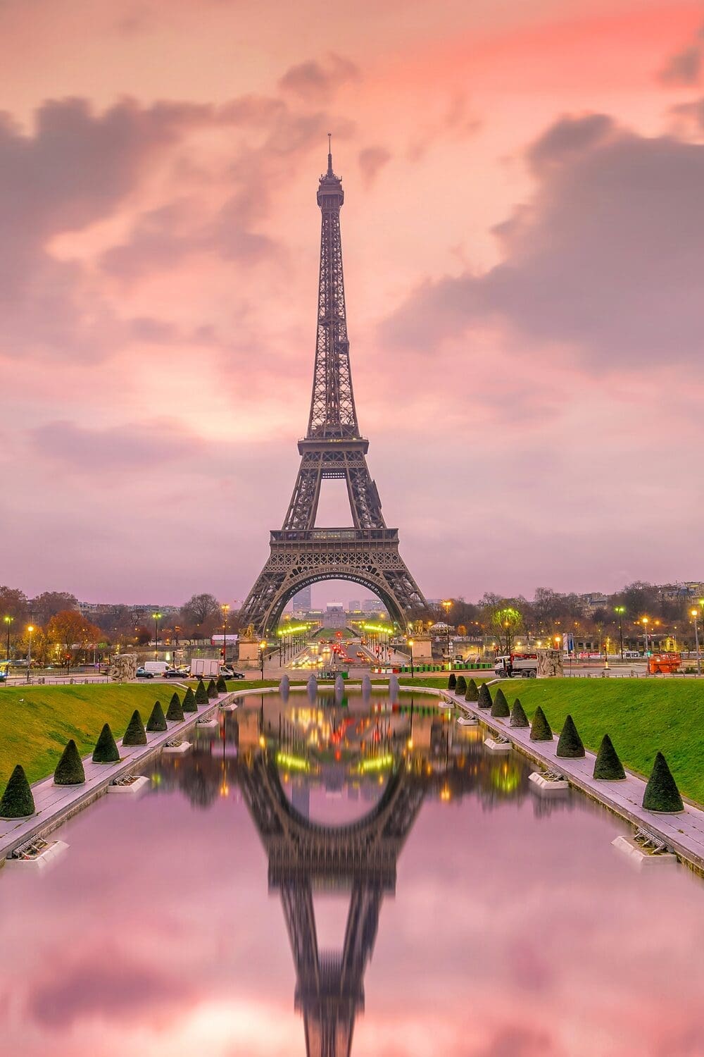 Eiffel Tower at sunset with pink and lavender sky reflecting in fountain at Trocadéro, Paris France Seine river cruise group trip 2027