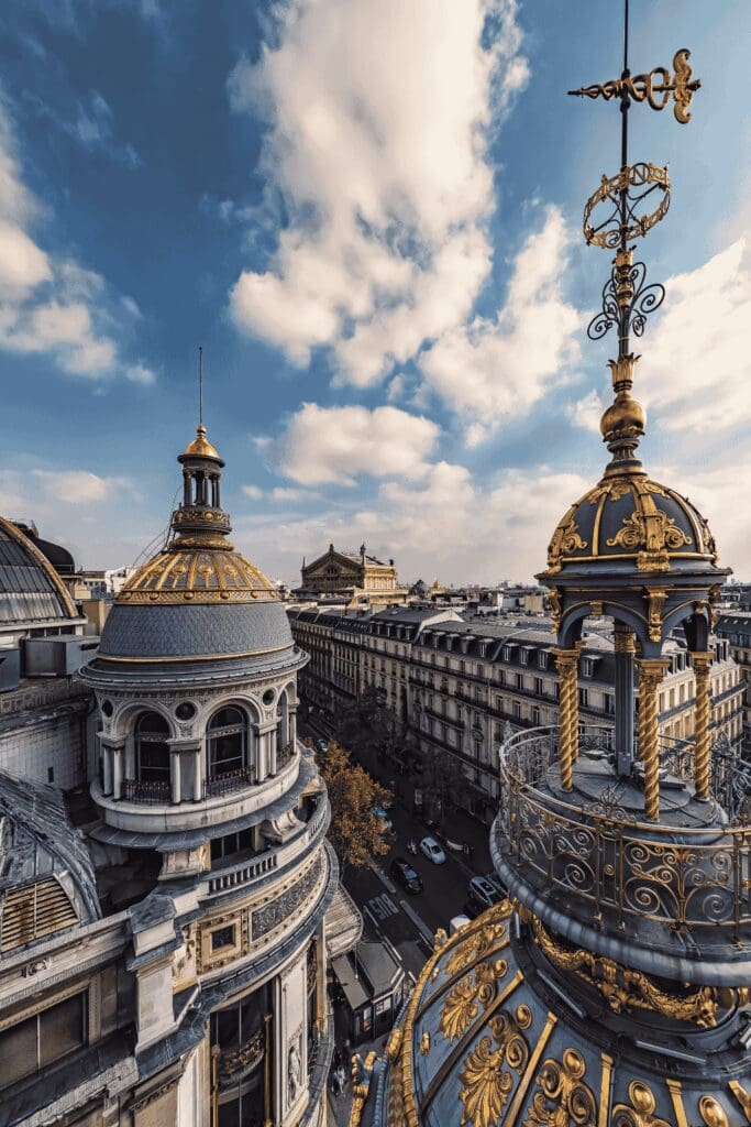 Paris rooftop view with ornate gold dome and Haussmann buildings luxury travel France