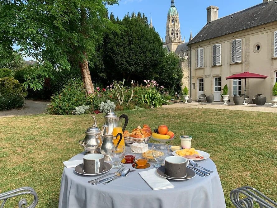 Luxury French breakfast in garden with croissants fresh juice and macarons boutique hotel France
