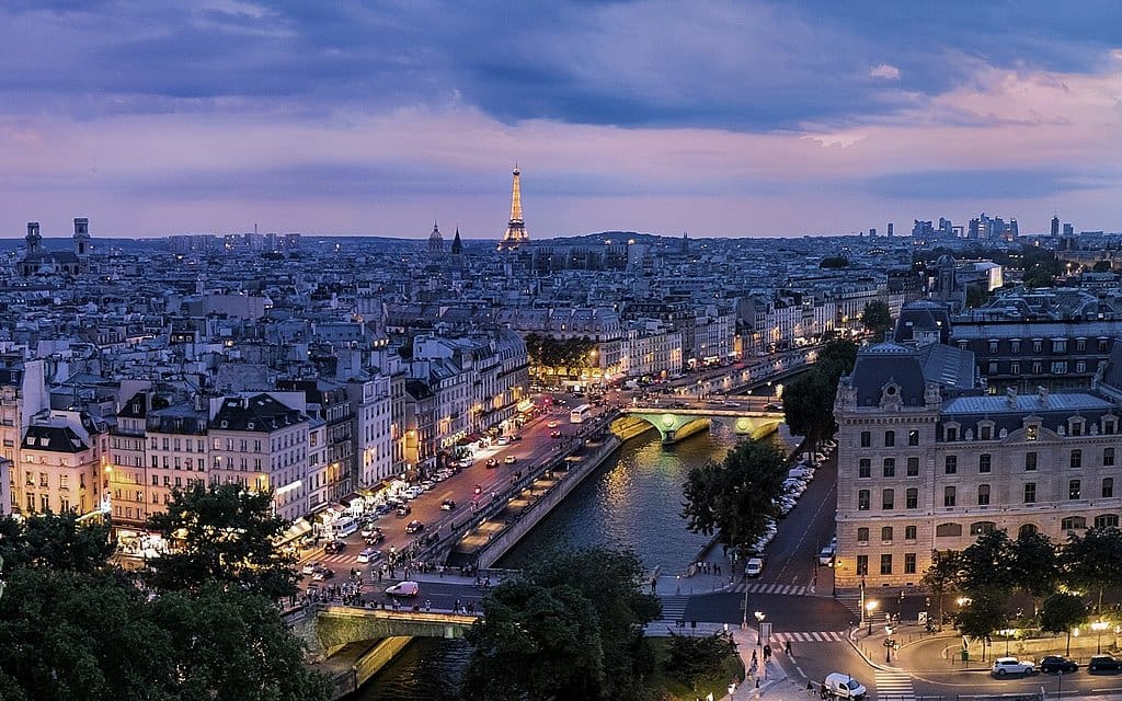 Paris at night aerial view Seine River glowing bridges and Eiffel Tower luxury travel France